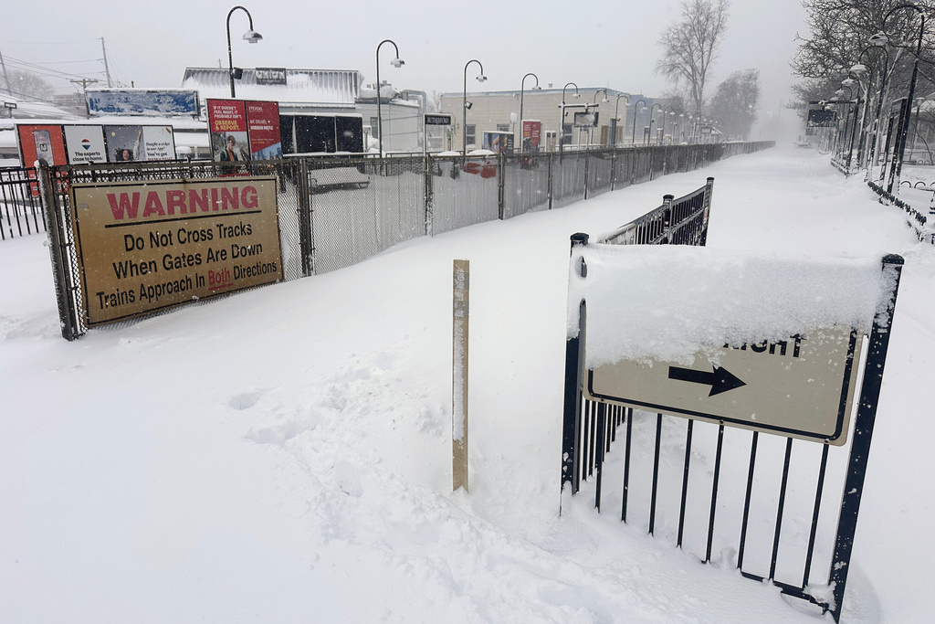 Snow covers a path at a train station in Rutherford, N.J., Monday, Feb. 23, 2026 after an intense snowstorm hit the area. (AP Photo/Ted Shaffrey)
