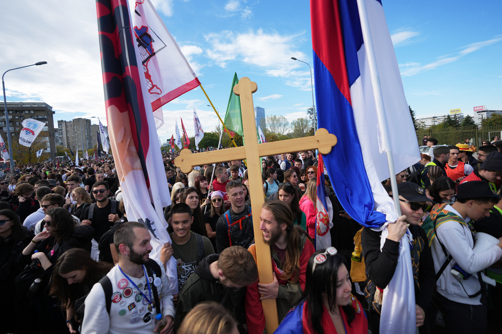 People gather, among them students, to walk on the street towards the northern city of Novi Sad, for a huge rally on Nov. 1 marking the first anniversary of a train station disaster that killed 16 people, in Belgrade, Serbia, Thursday, Oct. 30, 2025. (AP Photo/Darko Vojinovic)