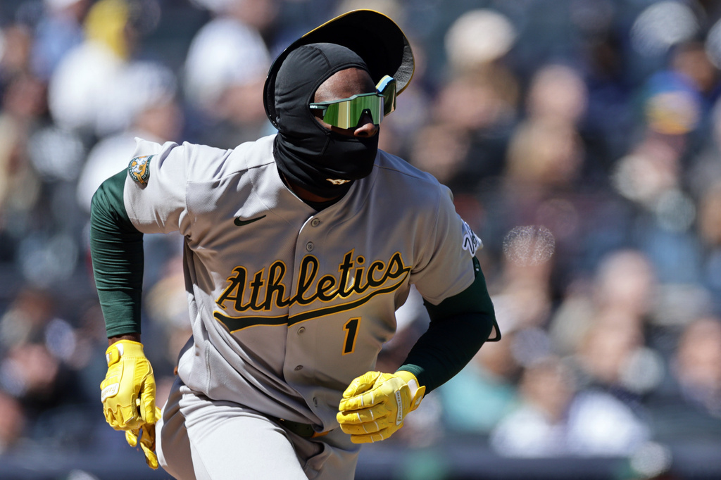Athletics' Denzel Clarke loses his bating helmet running out a flyout during the third inning of a baseball game against the New York Yankees, Thursday, April 9, 2026, in New York. (AP Photo/Adam Hunger)