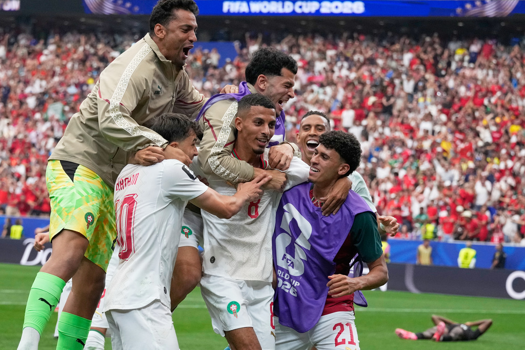 Morocco's Azzedine Ounahi, center, is congratulated by teammates after scoring his side's 2nd goal against Canada during the World Cup round of 16 soccer match in Houston, Saturday, July 4, 2026. (AP Photo/David J. Phillip)