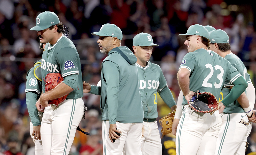Boston Red Sox manager Alex Cora, center, takes out pitcher Payton Tolle, left, during the sixth inning of a baseball game against the Pittsburgh Pirates, Friday, Aug. 29, 2025, in Boston. (AP Photo/Mark Stockwell)