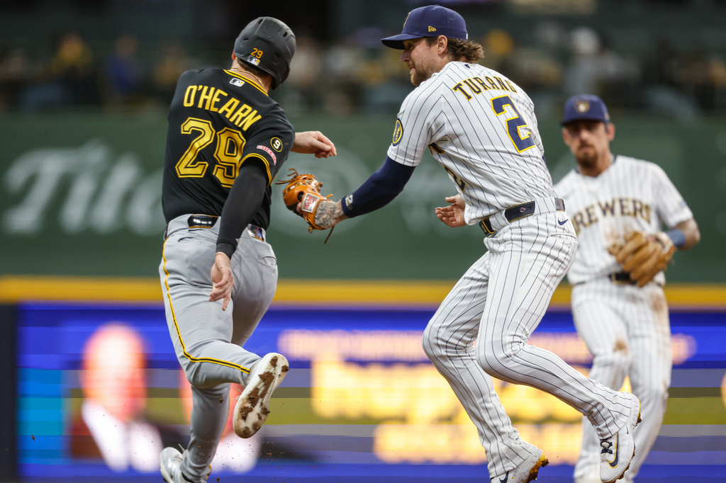 Milwaukee Brewers second baseman Brice Turang (2) tags out Pittsburgh Pirates' Ryan O'Hearn (29) in the base path during the fourth inning of a baseball game Saturday, April 25, 2026, in Milwaukee. (AP Photo/Jeffrey Phelps)
