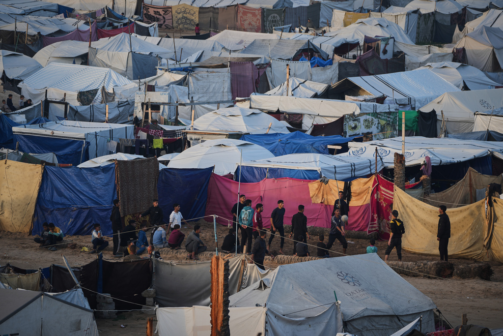 Young Palestinians play volleyball at a tent camp housing displaced families in Deir al-Balah, in the central Gaza Strip, Saturday, Jan. 10, 2026. (AP Photo/Abdel Kareem Hana)