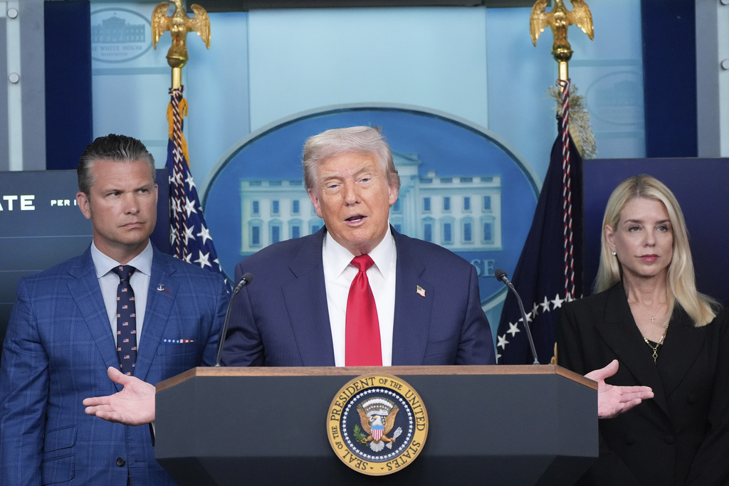 President Donald Trump speaks with reporters in the James Brady Press Briefing Room at the White House, Monday, Aug. 11, 2025, in Washington, as Secretary of Defense Pete Hegseth and Attorney General Pam Bondi look on. (AP Photo/Alex Brandon)