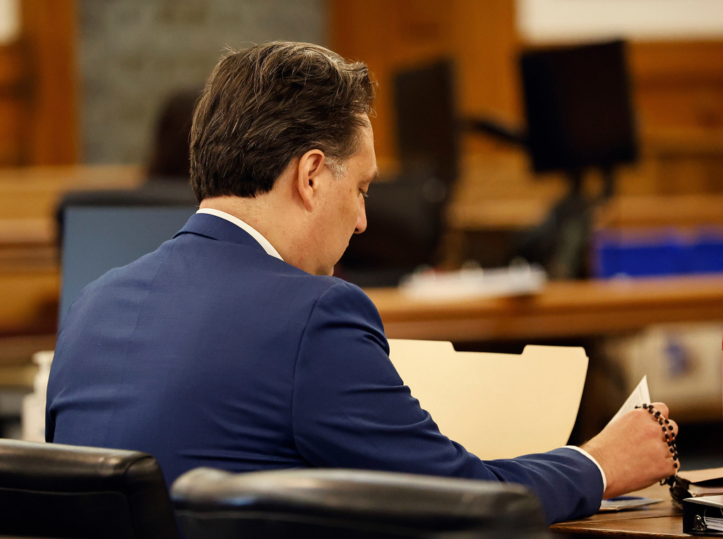 Brian Walsh looks over court papers. Opening statements in the Brian Walshe murder trial in Norfolk Superior Court, Dedham, Mass., Monday, Dec. 1, 2025 (Greg Derr/The Patriot Ledger via AP, Pool)