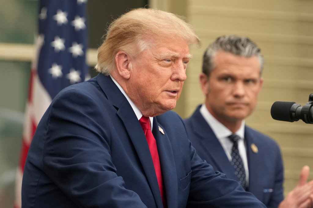 President Donald Trump speaks as Secretary of Defense Pete Hegseth listens during an observance ceremony on the 25th anniversary of the 9/11 attacks, Friday, Sept. 11, 2026, at the Pentagon in Washington. (AP Photo/Mark Schiefelbein)