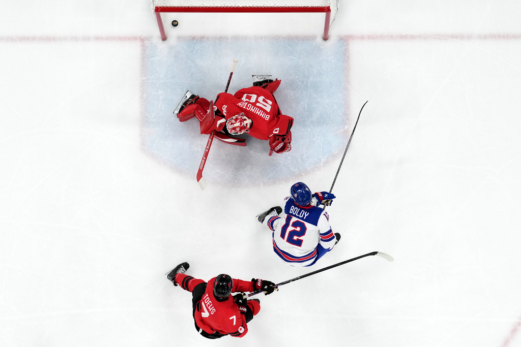 United States' Matt Boldy (12) scores his side's opening goal during a men's ice hockey gold medal game between Canada and the United States at the 2026 Winter Olympics, in Milan, Italy, Sunday, Feb. 22, 2026. (AP Photo/Nikos Seimenakis)