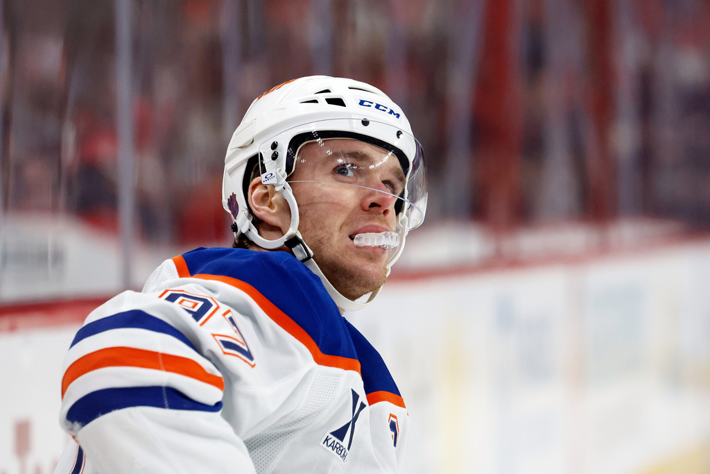 Edmonton Oilers' Connor McDavid (97) watches a replay during the first period of an NHL hockey game against the Carolina Hurricanes in Raleigh, N.C., Saturday, Nov. 15, 2025. (AP Photo/Karl DeBlaker)