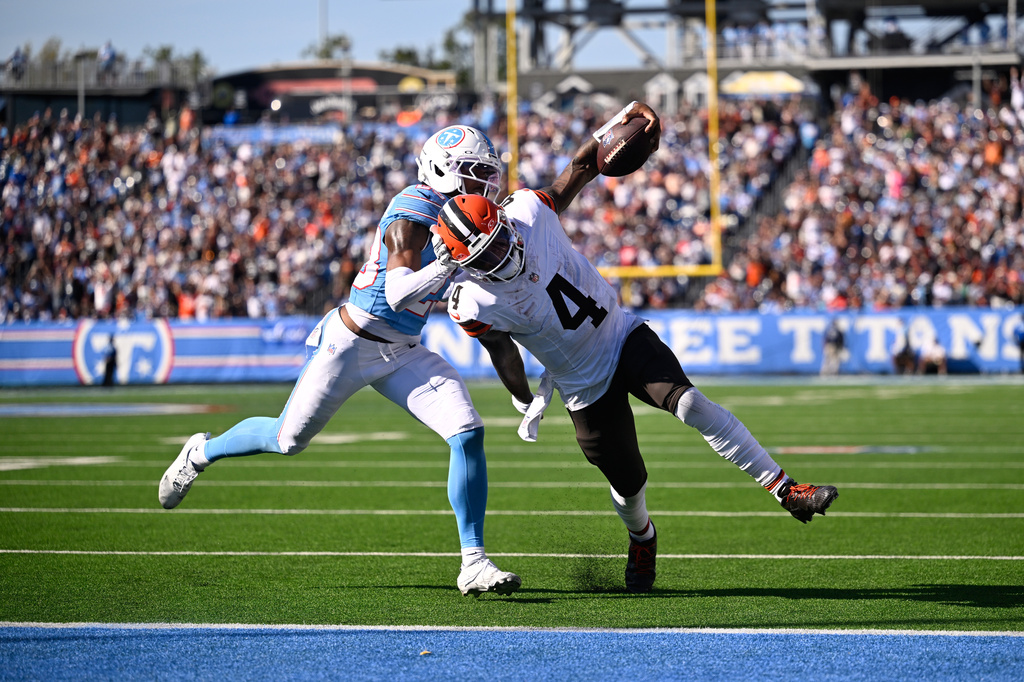 Cleveland Browns quarterback Deshaun Watson (4) scores a touchdown past Tennessee Titans safety Kevin Winston Jr. (23) during the second half of an NFL football game in Nashville, Tenn., Sunday, Oct. 25, 2026. (AP Photo/John Amis)