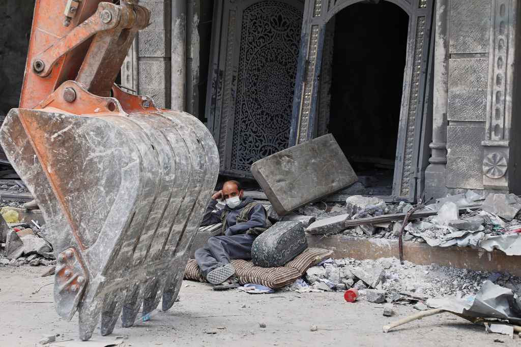 A man rests on the debris of his damaged home following Israeli airstrikes in Sanaa, Yemen, Friday, Sept. 26, 2025. (AP Photo)