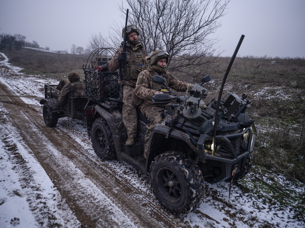 In this photo, taken Tuesday, Dec. 16, 2025 and provided by Ukraine's 93rd Kholodnyi Yar Separate Mechanized Brigade press service, soldiers ride a quad bike near Kostyantynivka, Donetsk region, Ukraine. (Iryna Rybakova/Ukraine's 93rd Mechanized Brigade via AP)