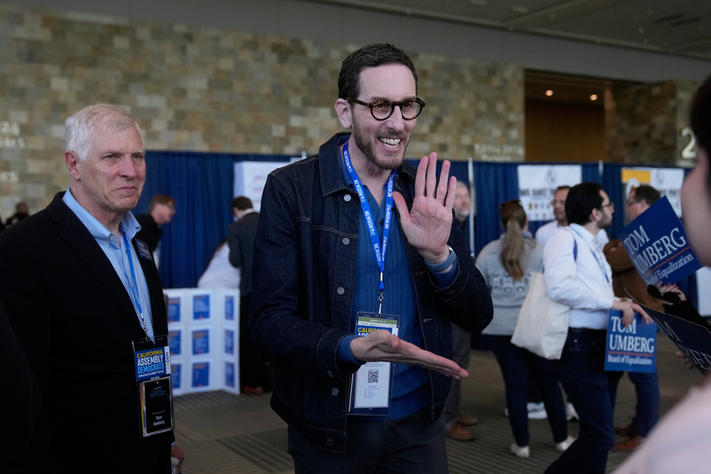 State Sen. Scott Wiener, center, smiles while speaking next to State Sen. Tom Umberg, left, at the 2026 California Democratic Party State Convention in San Francisco, Saturday, Feb. 21, 2026. (AP Photo/Jeff Chiu)