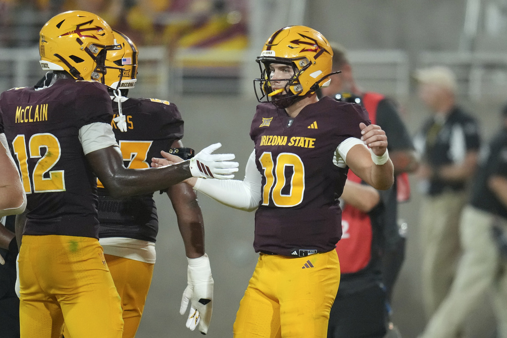 Arizona State quarterback Sam Leavitt (10) celebrates his touchdown run against Northern Arizona with Arizona State wide receiver Malik McClain (12) during the second half of an NCAA football game Saturday, Aug. 30, 2025, in Tempe, Ariz. (AP Photo/Ross D. Franklin)