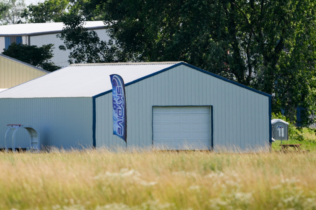A sign stands in front of a building at the Butler Memorial Airport in Butler, Mo., where a plane crashed occurred, Sunday, June 14, 2026. (AP Photo/Reed Hoffmann)