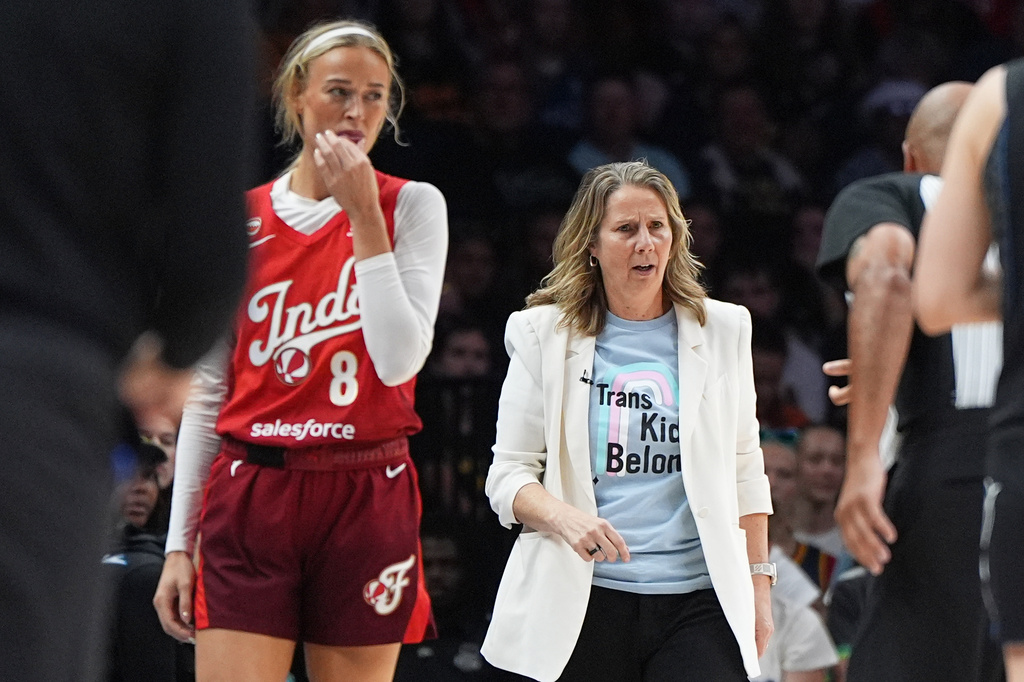 Indiana Fever guard Sophie Cunningham (8) and Minnesota Lynx head coach Cheryl Reeve, right, stand on the court during the first half of a WNBA basketball game Sunday, Aug. 2, 2026, in Minneapolis. (AP Photo/Abbie Parr)
