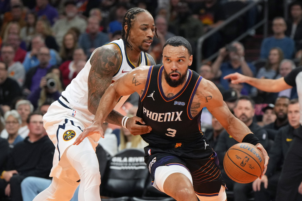 Phoenix Suns forward Dillon Brooks (3) drives around Denver Nuggets guard DeMar DeRozan, left, during the first half of an NBA Cup basketball game, Friday, Oct 30, 2026, in Phoenix. (AP Photo/Rick Scuteri)