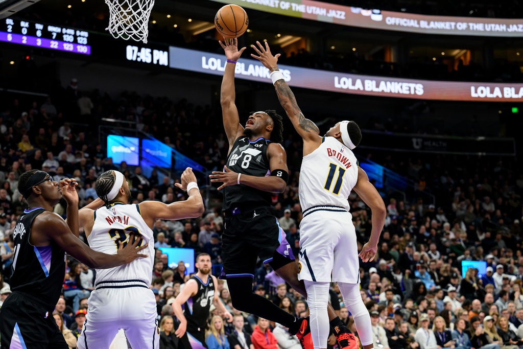 Utah Jazz guard Isaiah Collier (8) goes to the basket while guarded by Denver Nuggets guard Bruce Brown (11) during the first half of an NBA basketball game, Monday, March 2, 2026, in Salt Lake City. (AP Photo/Tyler Tate)