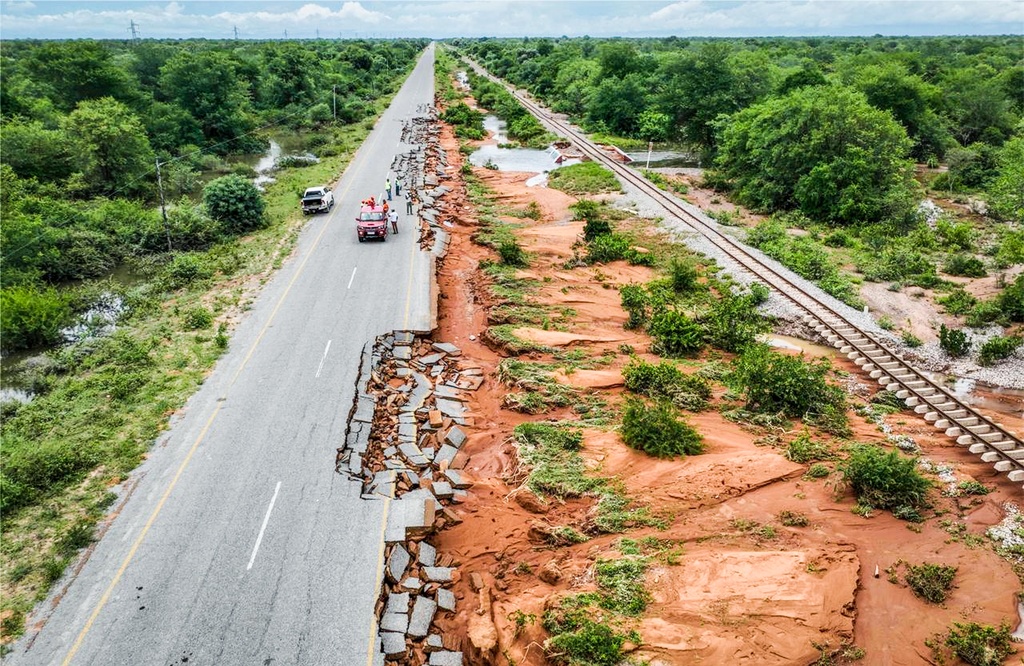 Travelers inspect the flood-damaged Combomune-Mapai road in Gaza province, Mozambique, Saturday, Jan. 17, 2026. (AP Photo)
