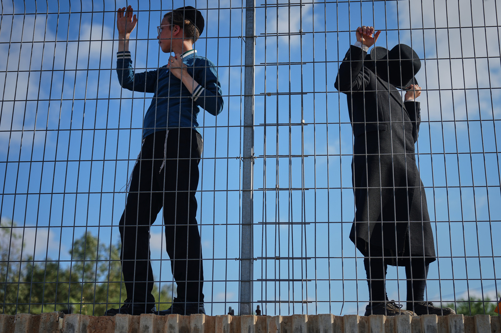 Ultra-Orthodox Jewish men protest against military recruitment and call for the release of detained draft resisters outside a military prison near Kfar Yona, Israel, Wednesday, June 17, 2026. (AP Photo/Ariel Schalit)