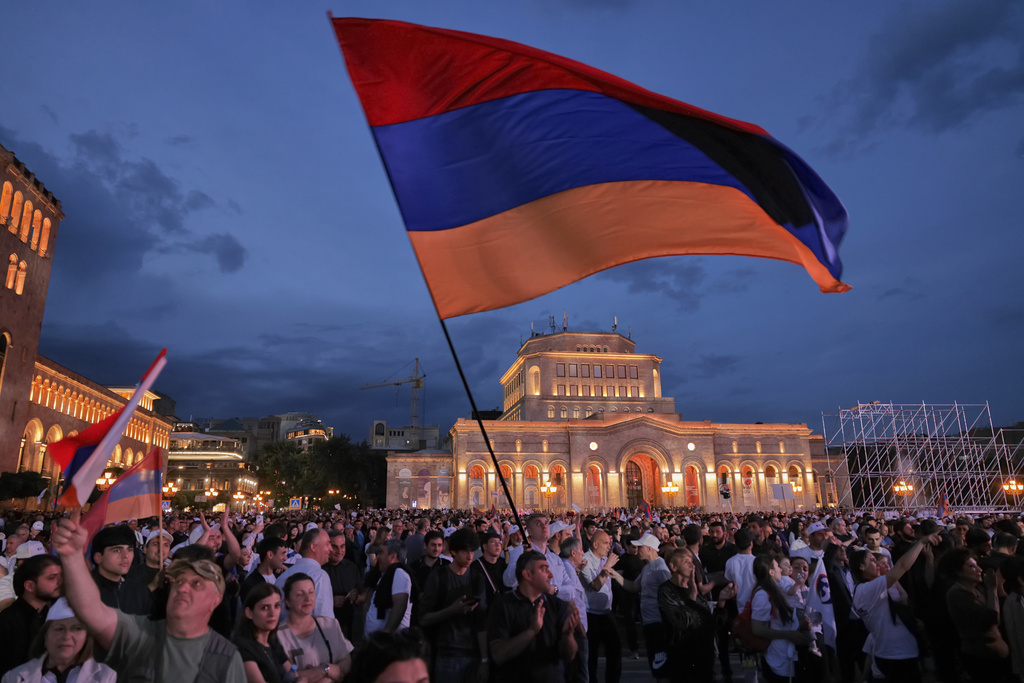 Supporters of Russian-Armenian tycoon Samvel Karapetyan, wave a Armenian national flag during a rally against incumbent Prime Minister Nikol Pashinyan at Republic Square in Yerevan, Armenia, Wednesday, June 3, 2026, as Karapetyan, who heads the Strong Armenia party, has faced criminal charges that he rejected as politically driven and campaigned from under house arrest. (AP Photo/Anthony Pizzoferrato)