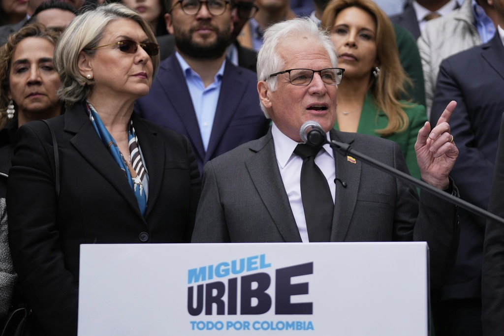 Miguel Uribe Londono, father of slain presidential candidate Miguel Uribe Turbay, reads a statement to officially announce his bid for the presidency in Bogota, Colombia, Tuesday, Aug. 26, 2025. (AP Photo/Fernando Vergara)