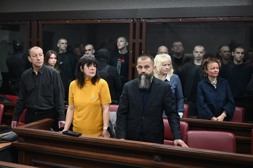 Lawyers of Ukrainian soldiers of the Aidar battalion captured by Russia during fighting in Ukraine stand in front of the defendants' cage during a hearing at the Southern District Military Court in Rostov-on-Don, Russia, Friday, Oct. 17, 2025. (AP Photo)