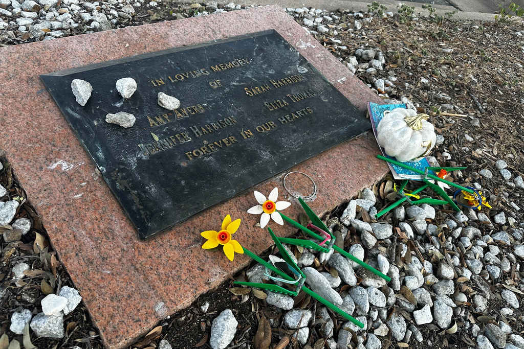 Tributes lay on a memorial Friday, Sept. 26, 2025, for four teenage girls who were killed in a yogurt shop in 1991 in Austin, Texas. (AP Photo/Paul J. Weber)