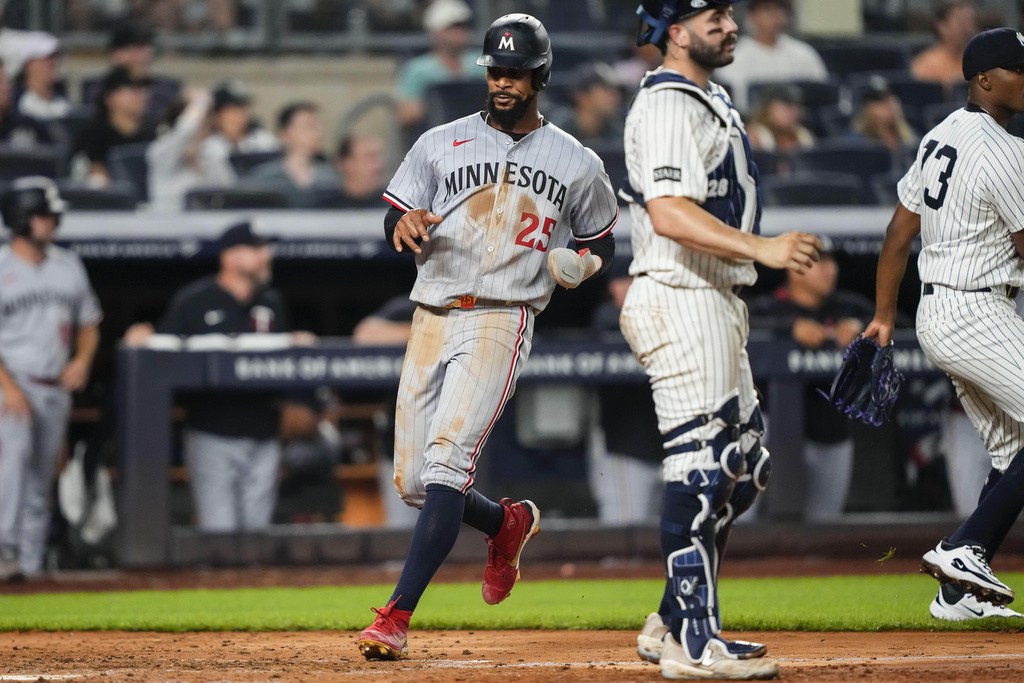 Minnesota Twins' Byron Buxton (25) scores during the sixth inning of a baseball game against the New York Yankees, Wednesday, Aug. 13, 2025, in New York. (AP Photo/Yuki Iwamura)