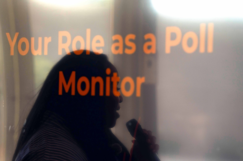 Rev. Medina Moore, an Arizona Faith Network voting rights organizer, is reflected on a television screen during a training for poll chaplains and peacekeepers, Tuesday, Oct. 6, 2026, ahead of the upcoming general midterm election, at Temple Chai in Scottsdale, Ariz. (AP Photo/Rebecca Noble)