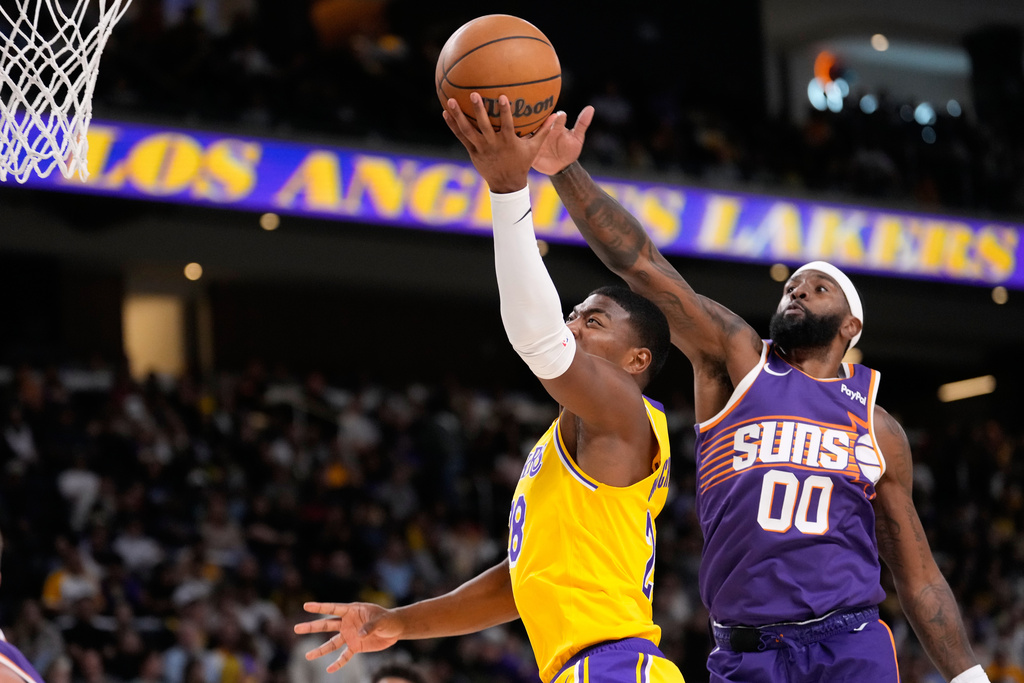 Los Angeles Lakers forward Rui Hachimura, left, shoots as Phoenix Suns forward Royce O'Neale defends during the first half of an NBA preseason basketball game Friday, Oct. 3, 2025, in Palm Desert, Calif. (AP Photo/Mark J. Terrill)