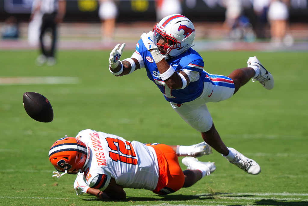A pass falls incomplete to Syracuse wide receiver Justus Ross-Simmons (12) as SMU defensive back Deuce Harmon (7) reaches for the ball during the first half of an NCAA college football game Saturday, Oct. 4, 2025, in Dallas. (AP Photo/LM Otero)