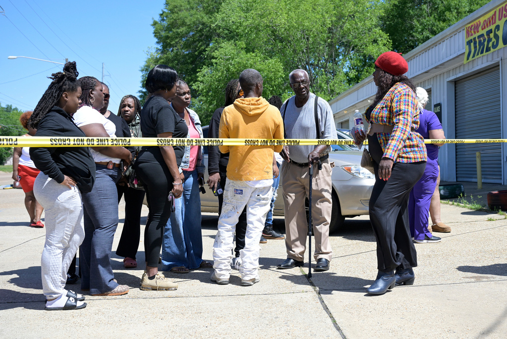 People gather at the corner of Linwood Avenue and 79th Street near where a mass shooting took place in Shreveport, La., Sunday, April 19, 2026. (Jill Pickett/The Times-Picayune/The New Orleans Advocate via AP)