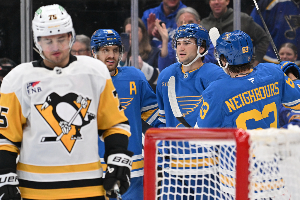 St. Louis Blues right wing Jimmy Snuggerud, right, is congratulated by teammates after scoring against the Pittsburgh Penguins during the second period of an NHL hockey game Tuesday, April 14, 2026, in St. Louis. (AP Photo/Jeff Le)