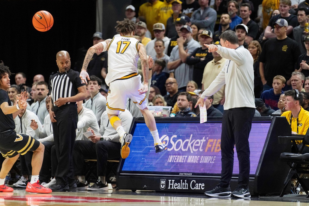 Missouri's Jayden Stone (17) saves the ball in front of Vanderbilt head coach Mark Byington, right, during the first half of an NCAA college basketball game Wednesday, Feb. 18, 2026, in Columbia, Mo. (AP Photo/L.G. Patterson)