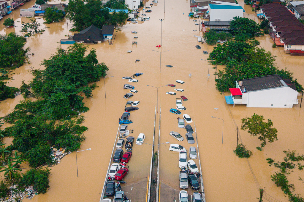 FILE - Cars and houses are submerged in floodwaters in the Songkhla province of southern Thailand, Nov. 26, 2025. (AP Photo/Arnun Chonmahatrakool, File)