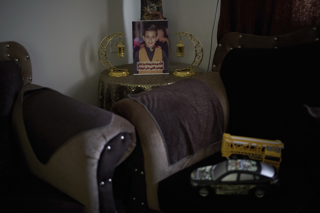 A photo of 12-year-old Ayman al-Heimouni, who was killed by Israeli gunfire, is displayed among Ramadan decorations in a room of his family's home in the West Bank city of Hebron, March 26, 2025. (AP Photo/Leo Correa)