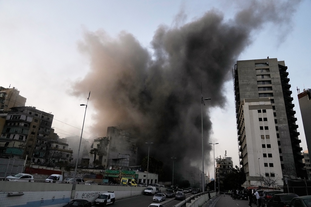 Smoke rises from a building targeted by an Israeli strike in central Beirut, Lebanon, Thursday, March 12, 2026. (AP Photo/Bilal Hussein)