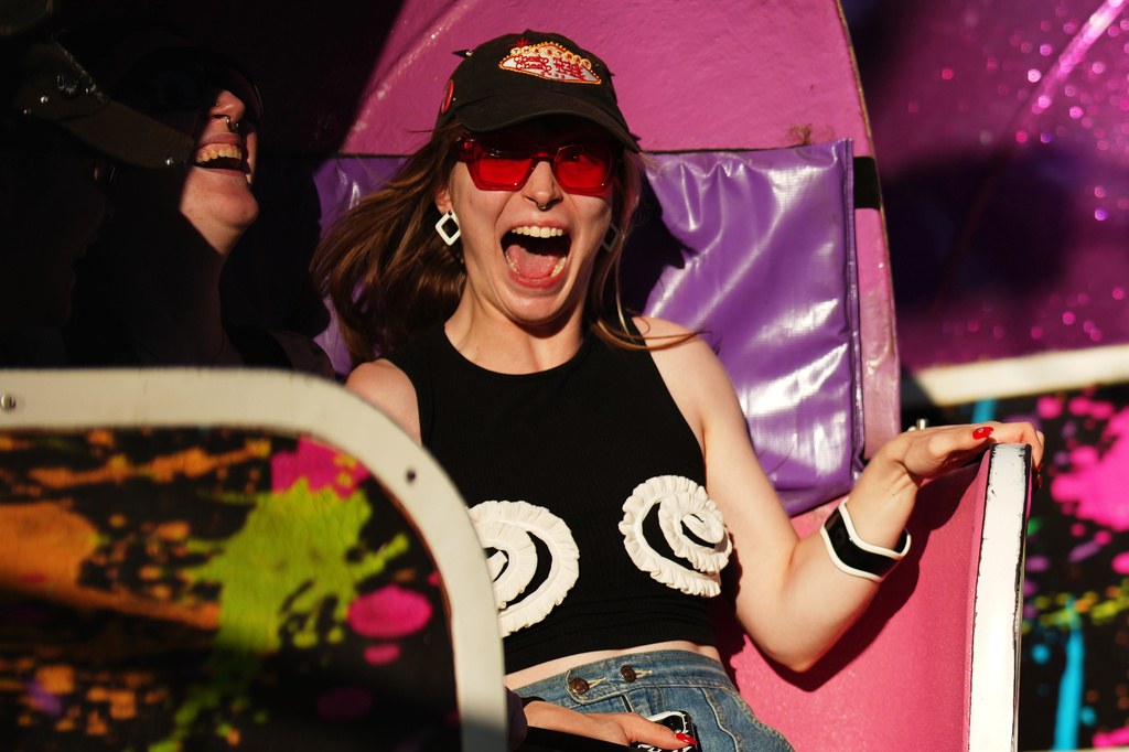 Lana Berge, of Minneapolis, screams while riding the Tilt-A-Whirl with friends Thursday, Aug. 27, 2026, at the Minnesota State Fair in Falcon Heights, Minn. (AP Photo/Ellen Schmidt)