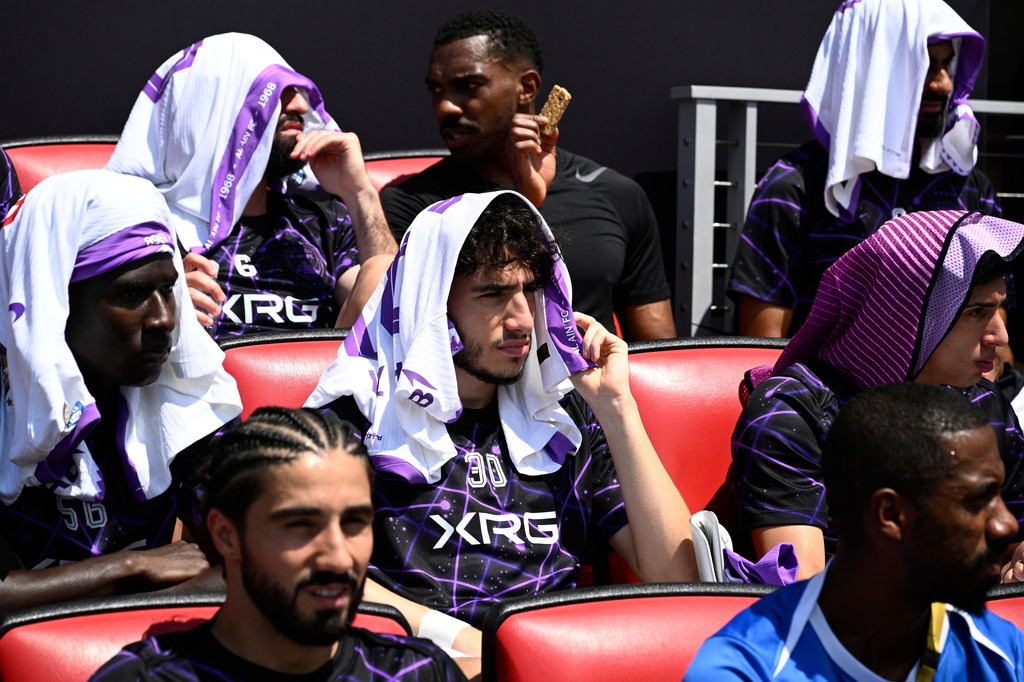 FILE - Al Ain's Hazim Abbas, center, shields himself from the sun with other players before the Club World Cup Group G soccer match between Wydad AC and Al Ain FC in Washington, June 26, 2025. (AP Photo/Nick Wass, File)