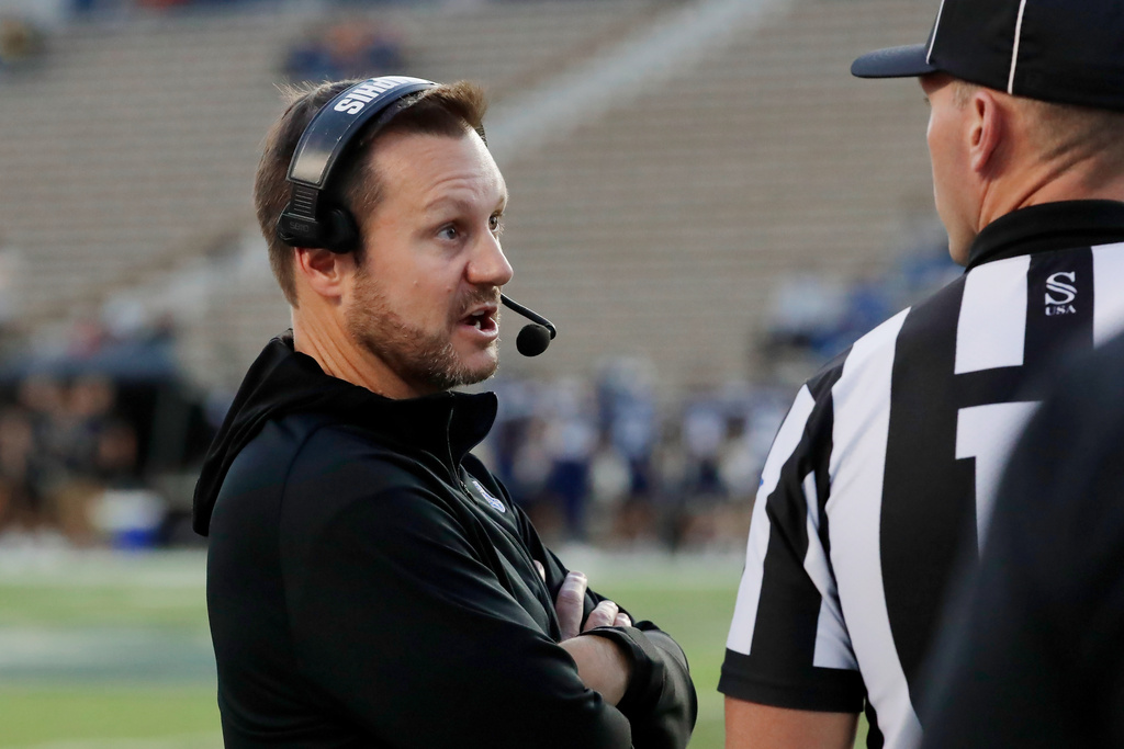 Memphis head coach Ryan Silverfield, left, talks with an official after a penalty during the first half of an NCAA college football game against Rice, Friday, Oct. 31, 2025, in Houston. (AP Photo/Michael Wyke)