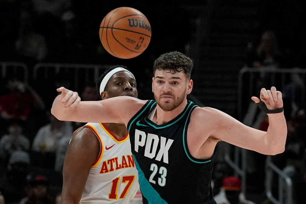 Portland Trail Blazers center Donovan Clingan (23) loses the ball against Atlanta Hawks forward Onyeka Okongwu (17) during the first half of an NBA basketball game, Sunday, March 1, 2026, in Atlanta. (AP Photo/Mike Stewart)