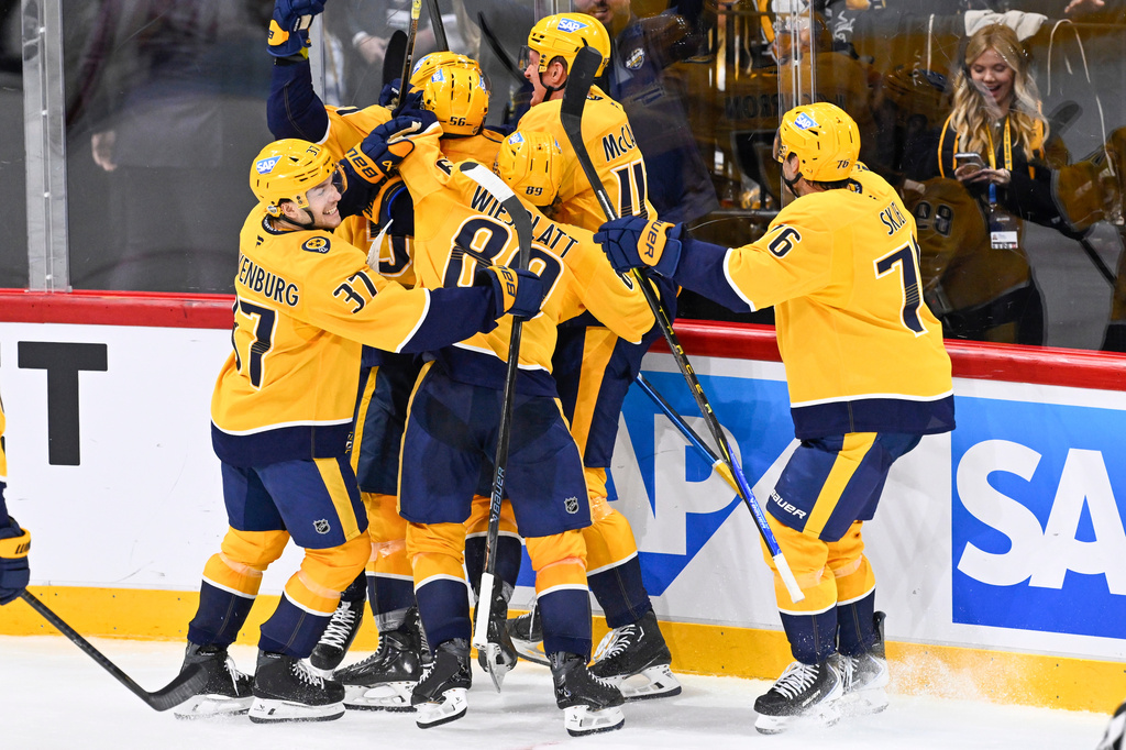 Nashville Predators' Steven Stamkos, obscured, is mobbed by teammates after scoring the game winning goal during overtime in the NHL Global Series hockey game against the Pittsburgh Penguins, Friday, Nov. 14, 2025, in Stockholm, Sweden. (Henrik Montgomery/TT News Agency via AP)