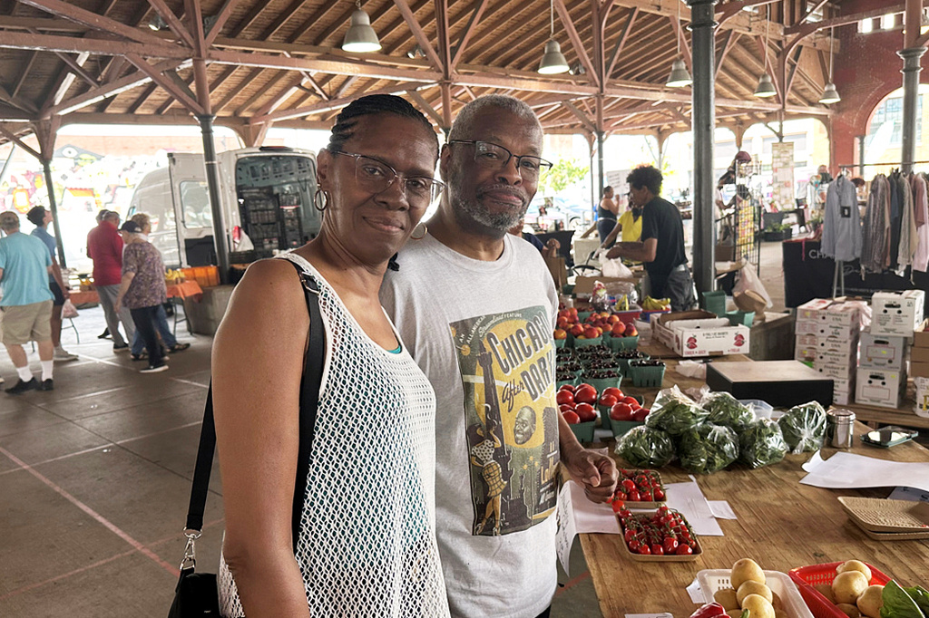 Karen and Ronald Hall shop for produce at the Eastern Market in Detroit on Tuesday, June 30, 2026. (AP Photo/Corey Williams)