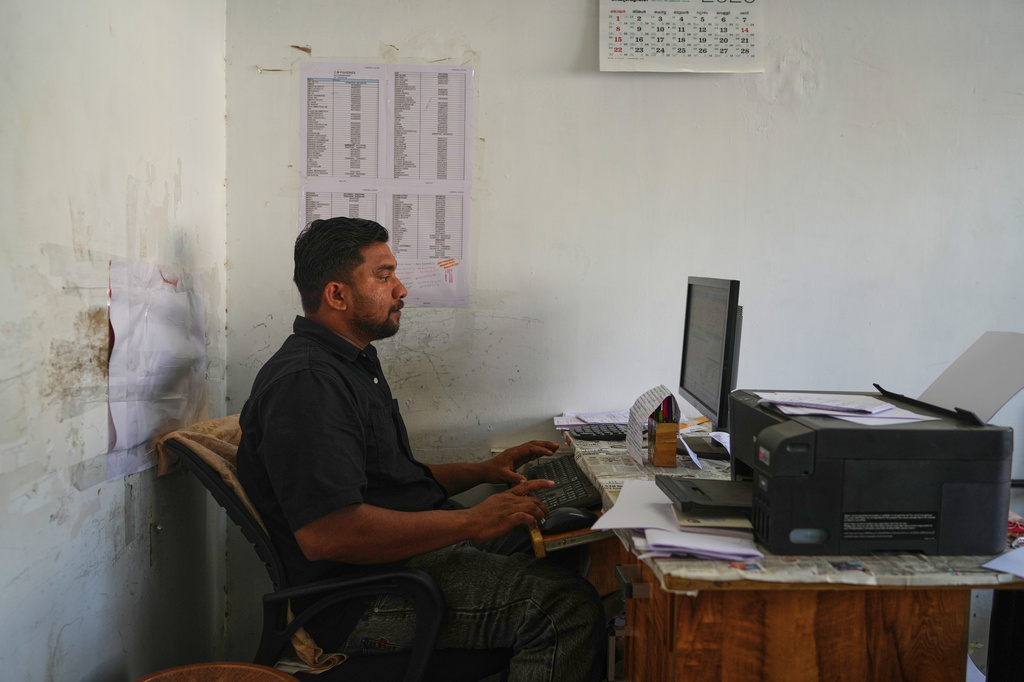 Safeer Mohammed Koorimannil, who was trafficked into scamming, works at his office in Sulthan Bathery, in the southern state of Kerala, India, after he said he paid more than $5,000 for his freedom, Thursday, March 12, 2026. (AP Photo/Manish Swarup)