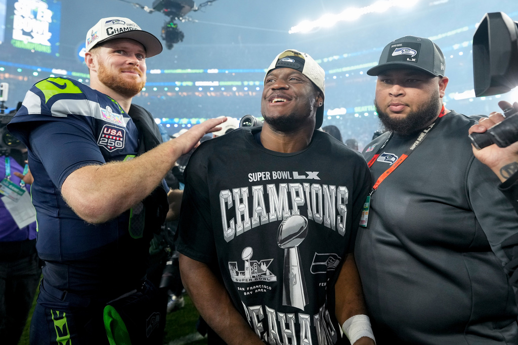 Seattle Seahawks quarterback Sam Darnold, left, and teammate running back Kenneth Walker III celebrate after defeating the New England Patriots in the NFL Super Bowl 60 football game, Sunday, Feb. 8, 2026, in Santa Clara, Calif. (AP Photo/Brynn Anderson)