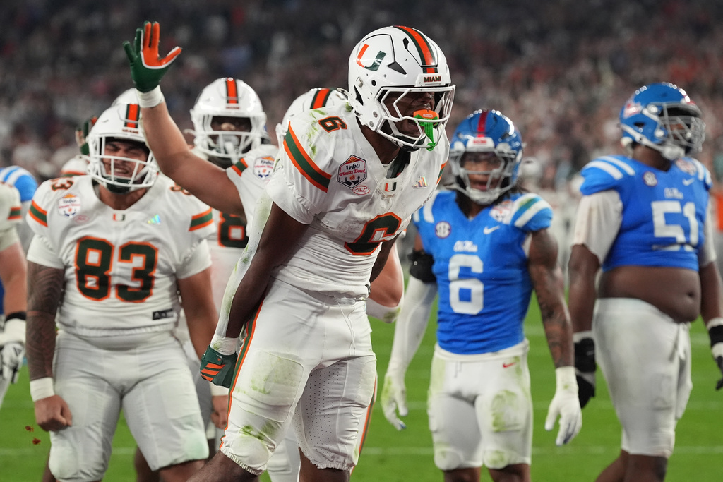 Miami running back Charmar Brown (6) celebrates after scoring a touchdown during the first half of the Fiesta Bowl NCAA college football playoff semifinal game against Mississippi, Thursday, Jan. 8, 2026, in Glendale, Ariz. (AP Photo/Ross D. Franklin)