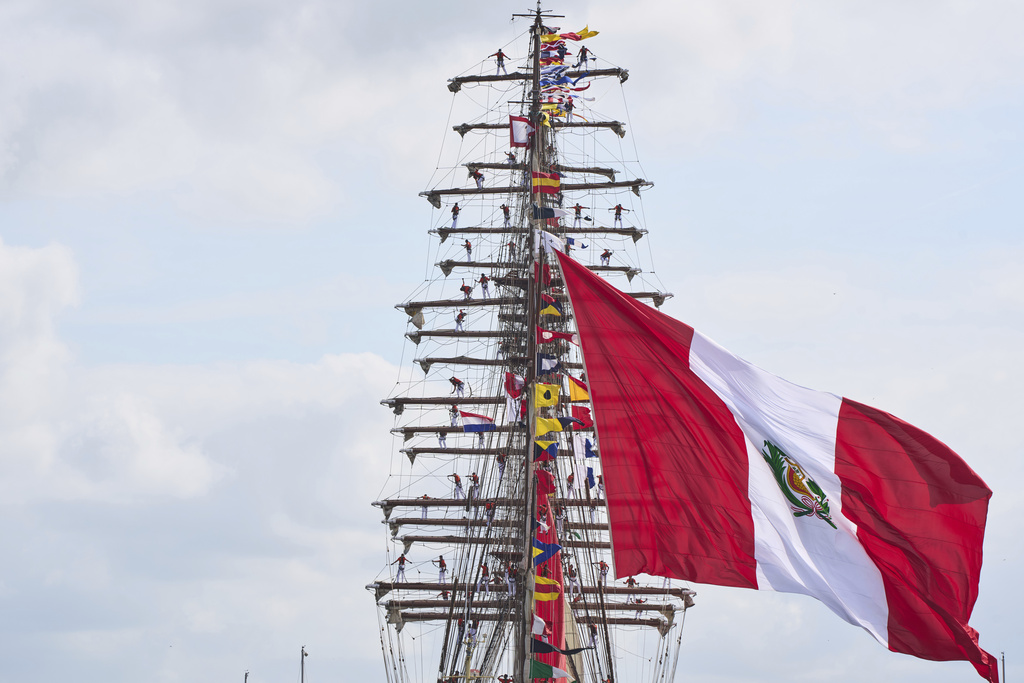 The crew of the Union, a tall ship from Peru, climbs in the masts as it sails with hundreds of tall ships into the Dutch capital's harbor for the 10th edition of SAIL, in Amsterdam, Netherlands, Wednesday, Aug. 20, 2025. (AP Photo/Peter Dejong)