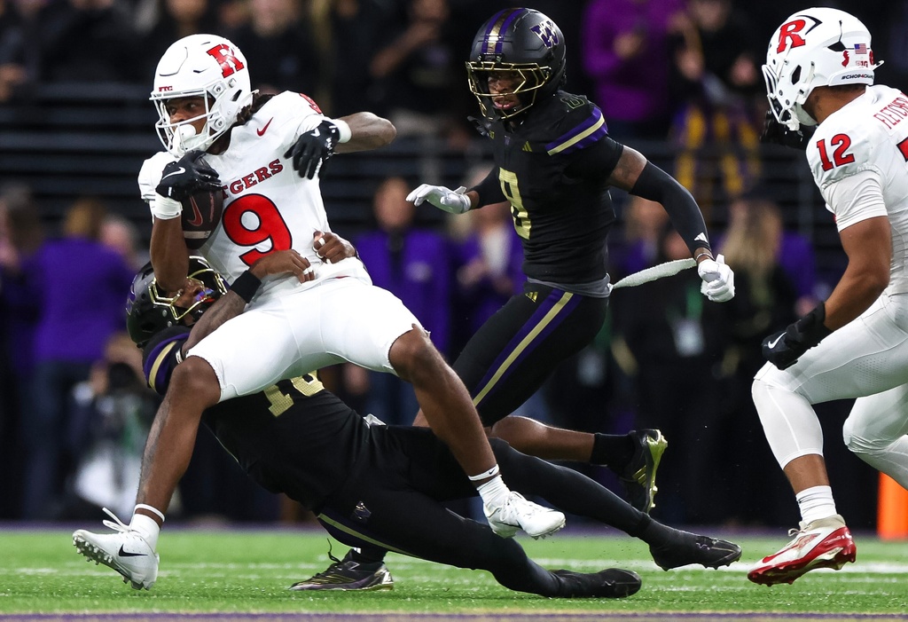 Washington safety Rylon Dillard-Allen (18) tackles Rutgers wide receiver Ian Strong (9) during a college football game on Friday, Oct. 10, 2025, i in Seattle. (Nick Wagner/The Seattle Times via AP)