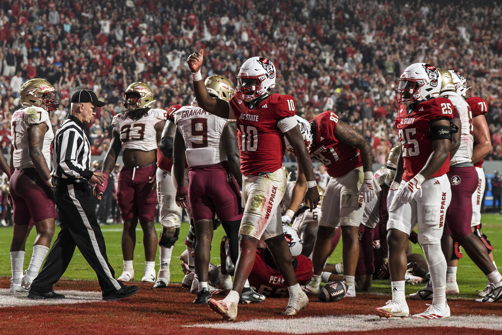 North Carolina State quarterback Will Wilson (10) gives a thumbs-up after scoring a touchdown during the second half of an NCAA college football game against Florida State, Friday, Nov. 21, 2025, in Raleigh, N.C. (AP Photo/David Yeazell)