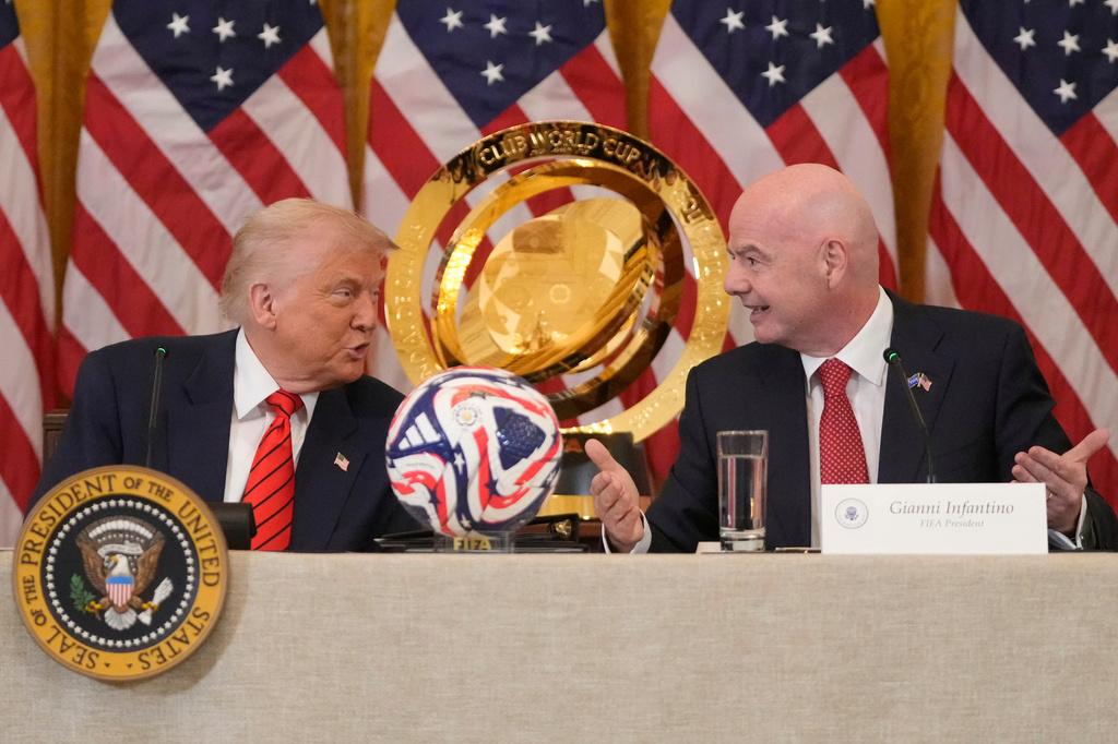 FILE - President Donald Trump and FIFA President Gianni Infantino talk during a FIFA task force meeting in the East Room of the White House, May 6, 2025, in Washington. (AP Photo/Mark Schiefelbein, File)